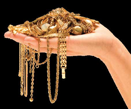 A hand holding gold chains, bracelets and jewellery